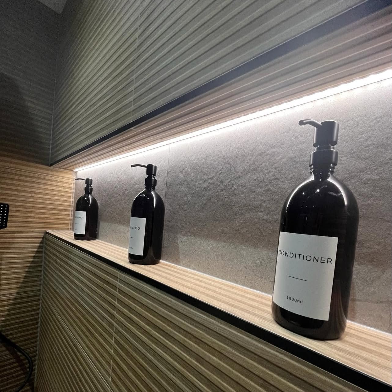LED strip lighting set into a tiled shower niche